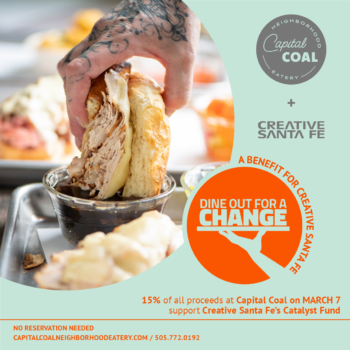 Creative Santa Fe’s Dine Out A Change promo card featuring Capital Coal. A tatooed hand holding a cut baguette sandwich dipping it into a bowl of dark vinegar.